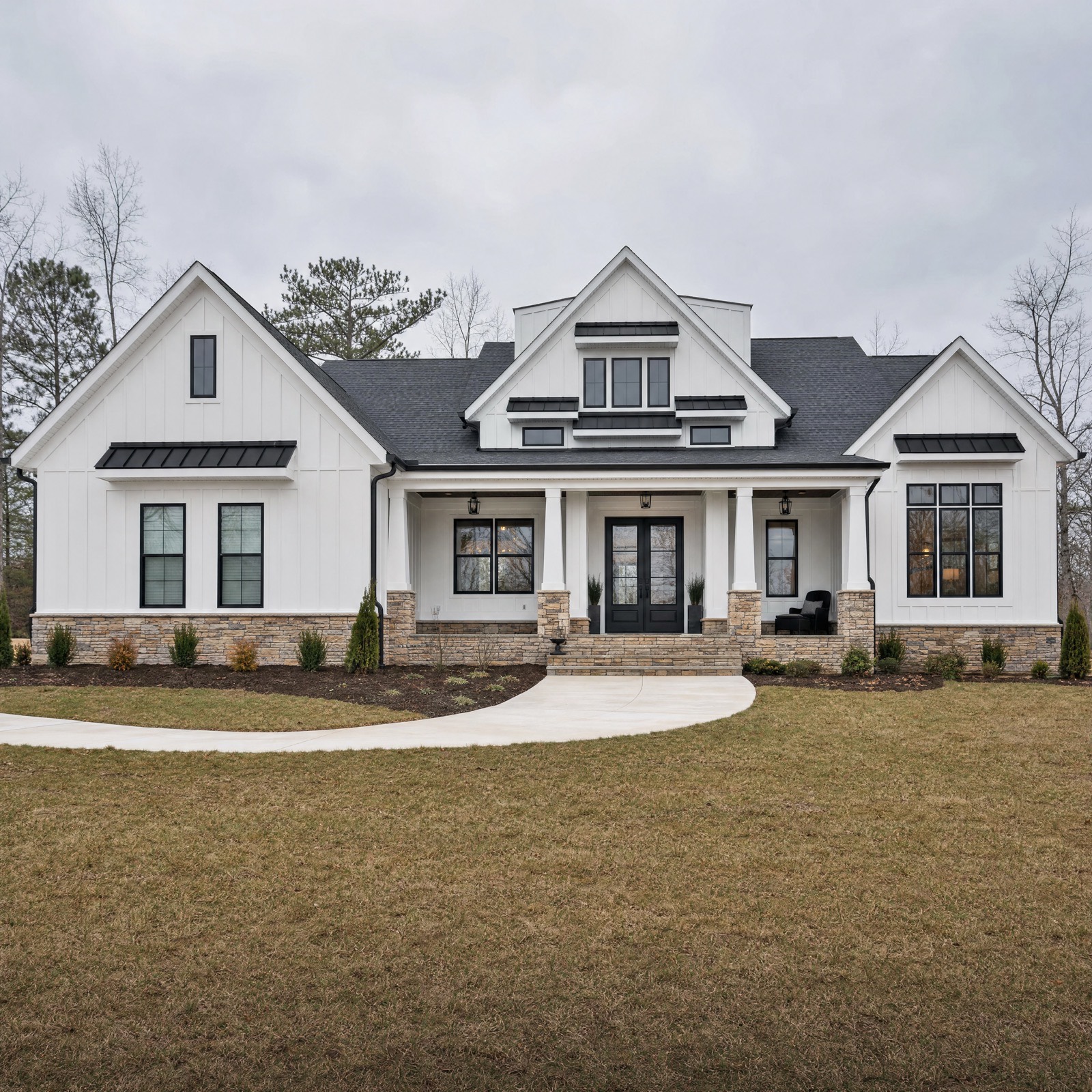 White board and batten modern farmhouse with black windows, stone base and a full width covered front porch in Center Valley, Pennsylvania